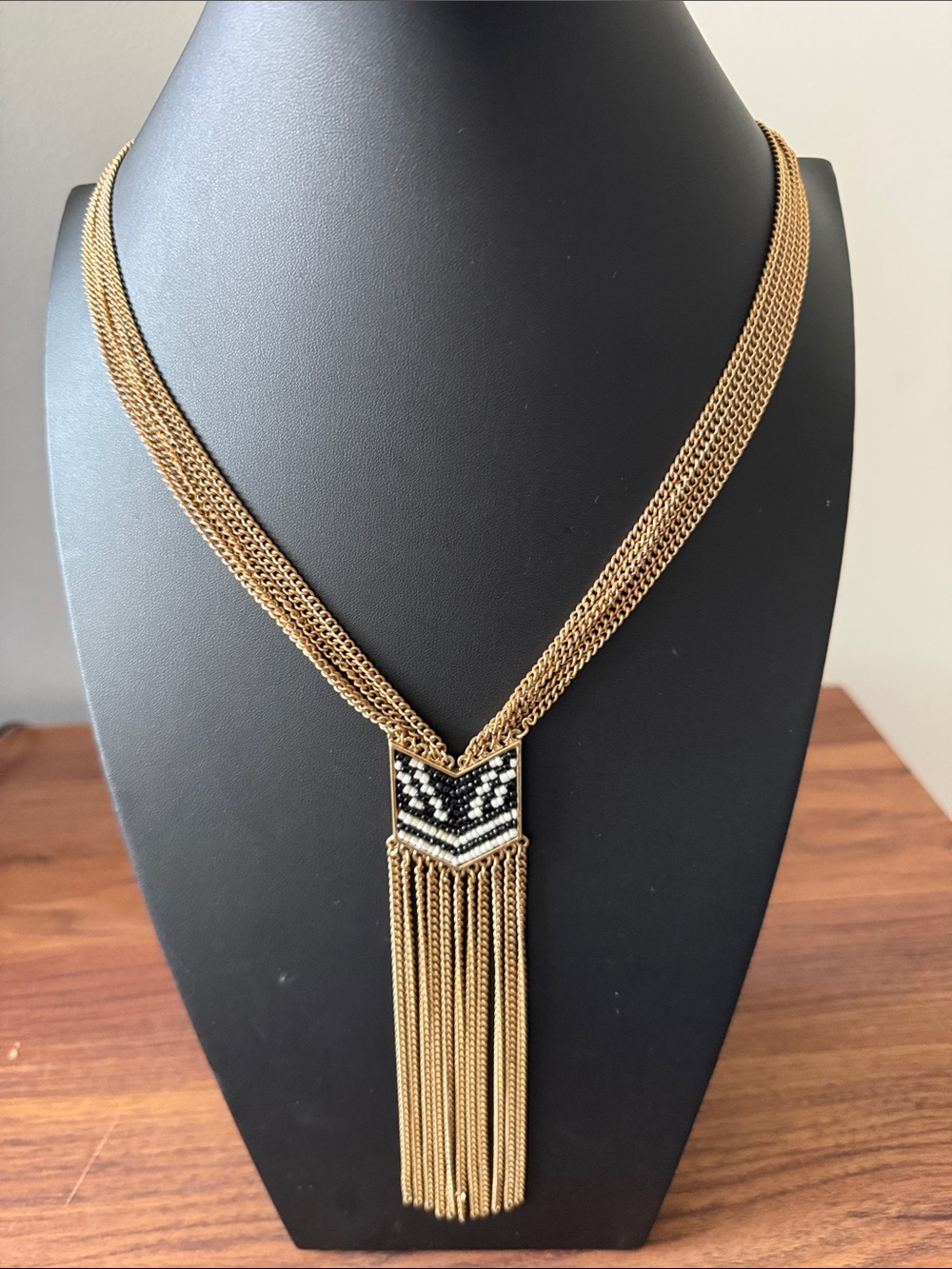 Gold Tone Multistrand Necklace with Chevron Seed Bead Pendant & Tassel Trim.